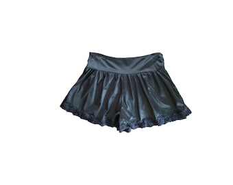 May include: Black satin shorts with a ruffled hem and black lace trim.