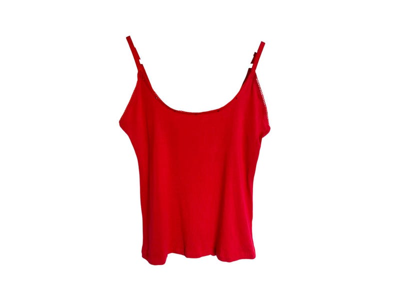 May include: A red sleeveless tank top with thin straps.