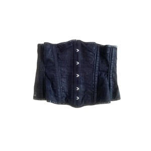 May include: A black corset with a checkered pattern and silver buttons.