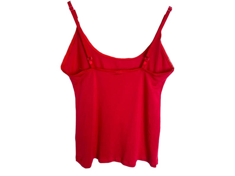 May include: A red sleeveless tank top with adjustable straps.
