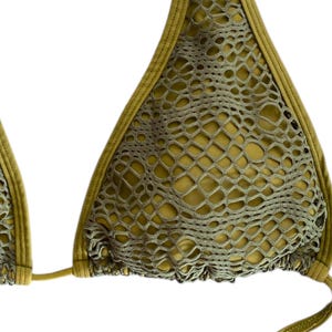 May include: A green mesh bikini top with a halter style and adjustable straps.