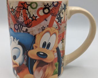 Taza Disney: Mickey Mouse, el Pato Donald, Goofy y Pluto / Jerry Leigh
