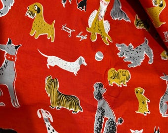 May include: Red fabric featuring a playful pattern of dogs in various breeds and poses, including poodles and dachshunds. The dogs are in yellow, grey, black, and white. The fabric also has the text "friends" in white.