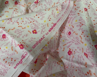 May include: White fabric featuring a repeating pattern of small pink flowers, orange sprigs, and yellow dots. The selvage edge displays the printed text "wee wander by sarahjane for michael miller fabrics llc all rights reserved" in a dark pink font.