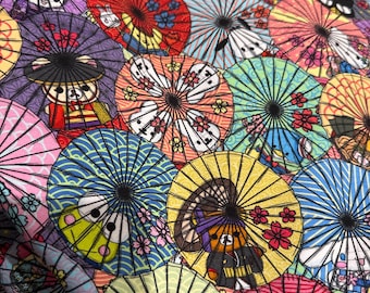 May include: A close-up of a fabric covered in colourful Japanese parasols. The parasols display a variety of designs, including floral patterns and cartoon characters. The colour scheme includes red, yellow, blue, purple, and pink.