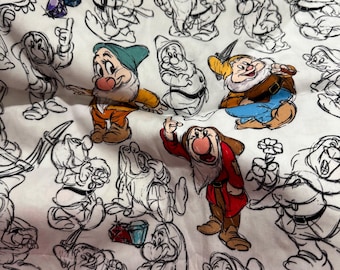 May include: A white fabric featuring a repeating pattern of the Seven Dwarfs. Some figures are fully coloured in shades of red, blue, yellow, and green, while others are depicted as black line art sketches. Several colourful gemstones are scattered throughout.
