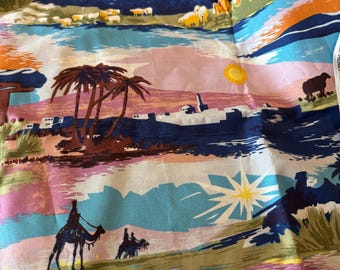 May include: A patterned fabric with a desert scene. The design includes camels, palm trees, and a bright sun. The colour scheme features blue, orange, pink, and green.