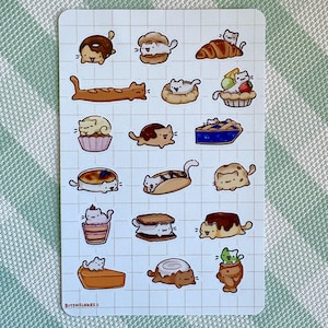 May include: A sticker sheet with cartoon cats incorporated into different pastries. The illustrations include a donut, croissant, pie, and other desserts. The text "Bitsnflakes=" is at the bottom left.