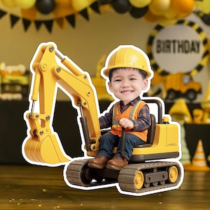 May include: A yellow toy excavator with a smiling child wearing a construction hat and vest. The excavator has a detailed bucket and tracks. The background includes birthday decorations with the word "BIRTHDAY".