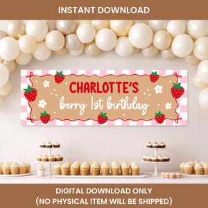May include: A rectangular party banner featuring a light pink and white checkered border, a tan center, and red strawberry illustrations. The text reads Charlotte's berry 1st birthday in red and white script and block lettering with white flowers.