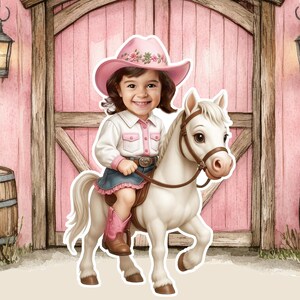 May include: A child in a pink cowboy hat and boots, white shirt with pink trim, and denim skirt, riding a white toy horse. The hat has floral details. The background shows a pink barn door. The saddle is brown.