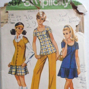 May include: Vintage Simplicity sewing pattern with illustrations of three women's outfits. The designs include a plaid top and trousers, a vest and skirt, and a blue dress. The pattern includes the text "Mini-Length".