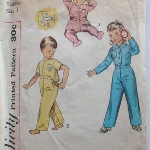 May include: Vintage Simplicity printed pattern for toddler pajamas, size 1. The pattern features illustrations of children in various pajama styles, including a pink jumpsuit, a yellow two-piece set, and a blue jumpsuit. The pattern number is 3377.