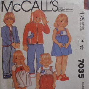 May include: McCall's sewing pattern envelope featuring illustrations of children's clothing. The designs include a blue jacket and striped pants, a red jacket and blue pants, a blue dress, a white dress, and red overalls. The envelope has the text "McCall's" and "7035".