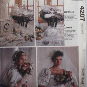 May include: A sewing pattern for wedding accessories, including a bridal bouquet, gloves, a pillow, and a decorative basket. The pattern is called "Wedding Bells" and is from McCall's Crafts. The pattern number is 4207.