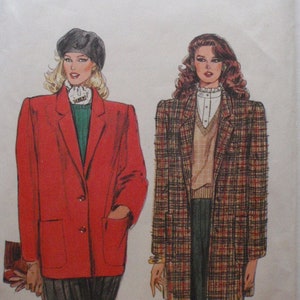 May include: A Very Easy Very Vogue sewing pattern envelope 8426 for sizes 18-20-22. The illustration shows two blazer styles: one solid red blazer with patch pockets and one plaid blazer with patch pockets, both worn over layered tops and dark trousers.