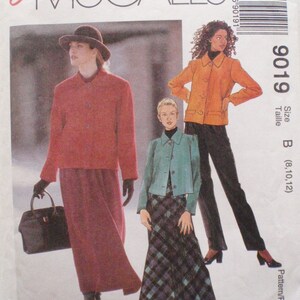 May include: McCall's sewing pattern featuring three women's outfits. The outfits include a red jacket and skirt, an orange jacket and black pants, and a teal jacket and plaid skirt. The pattern is labeled "Easy McCall's".