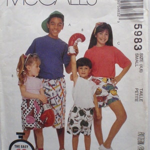 May include: McCall's sewing pattern envelope featuring a group of children wearing shorts and t-shirts. The pattern includes sizes 4 and 6. The text on the envelope reads "The Easy 60 min Pattern".