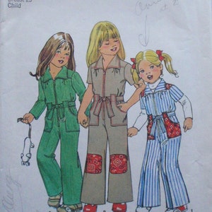 May include: Simplicity sewing pattern 7277 for a child's jumpsuit, size 4, breast 23 inches. The illustration shows three children wearing jumpsuits in green, tan, and blue striped fabric. The tan jumpsuit has red paisley knee patches.