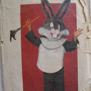 May include: Vintage Butterick sewing pattern for a Bugs Bunny costume. The pattern envelope features a Bugs Bunny illustration holding a carrot, with the Looney Tunes logo and the text "ONE-SIZE ALL SIZES (S-M-L) IN ONE ENVELOPE".