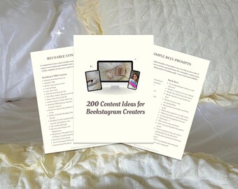May include: Three cream-colored sheets of paper with text, including "200 Content Ideas for Bookstagram Creators." The image shows a computer monitor and two mobile devices with images. The papers are on a white and yellow bedspread.