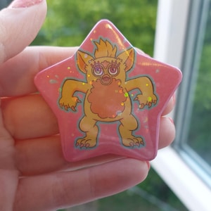 Furby With Limbs Star Holographic Button Pin Badge