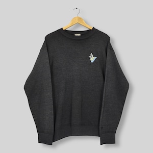 May include: Dark gray sweatshirt with a small, colorful logo on the upper left chest. The logo features a geometric design with blue, yellow, and white accents. The sweatshirt is hanging on a wooden hanger against a neutral background.