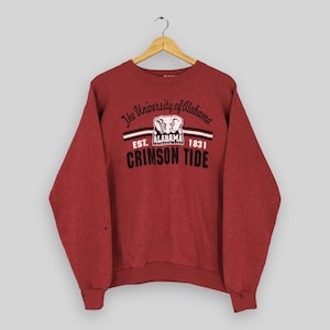 May include: Crimson red crewneck sweatshirt with the text "The University of Alabama" and "Crimson Tide". The sweatshirt features a graphic of an elephant and the text "EST. ALABAMA 1831".