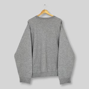 May include: A rustic wooden sign with the text "Welcome to our home" in white lettering. The sign features a distressed finish and a simple, inviting design, perfect for front door decor.