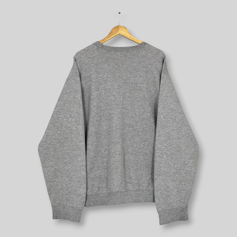 May include: A rustic wooden sign with the text "Welcome to our home" in white lettering. The sign features a distressed finish and a simple, inviting design, perfect for front door decor.