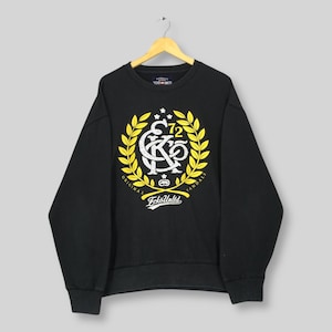May include: Black crew neck sweatshirt with a white and yellow graphic. The graphic features a crest design with the text "Ecko Unltd" and "Original Vandals". The sweatshirt is hanging on a wooden hanger.