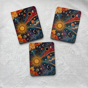 May include: Three rectangular covers featuring a vibrant celestial design. Each cover displays a central golden sun with radiating light beams, surrounded by colorful planets, stars, and swirling clouds against a deep dark blue cosmic background.