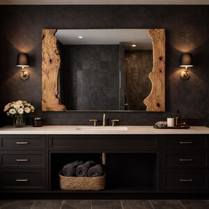 May include: A contemporary bathroom vanity with a large mirror framed in natural wood. The dark cabinets have drawers and an open shelf with a woven basket. A white countertop holds a sink, gold tap, and decorative items.