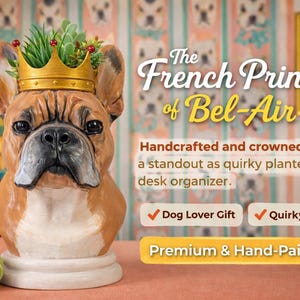 May include: A handcrafted, hand-painted planter shaped like a French Bulldog wearing a gold crown, with greenery inside. The planter is a quirky desk organizer. The text reads "The French Prince of Bel-Air."