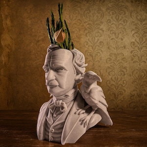 May include: A white bust of a man with a raven on his shoulder, and greenery emerging from the head. The bust is set against a brown and gold patterned background, creating a vintage aesthetic.