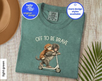 Comfort Colors Off to Be Brave Monkey Punch Scooter Shirt, Baby Monkey Holding Plush Toy T-Shirt, Funny Animal Lover, Viral Sad Monkey Meme