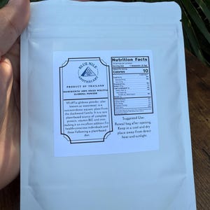 May include: White pouch of Blue Nile Apothecary Wolffia globosa powder. The label includes nutrition facts and suggested use. The product is from Thailand and contains 100% dried Wolffia globosa powder.