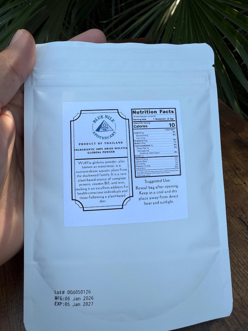 May include: White pouch of Blue Nile Apothecary Wolffia globosa powder. The label includes nutrition facts and suggested use. The product is from Thailand and contains 100% dried Wolffia globosa powder.