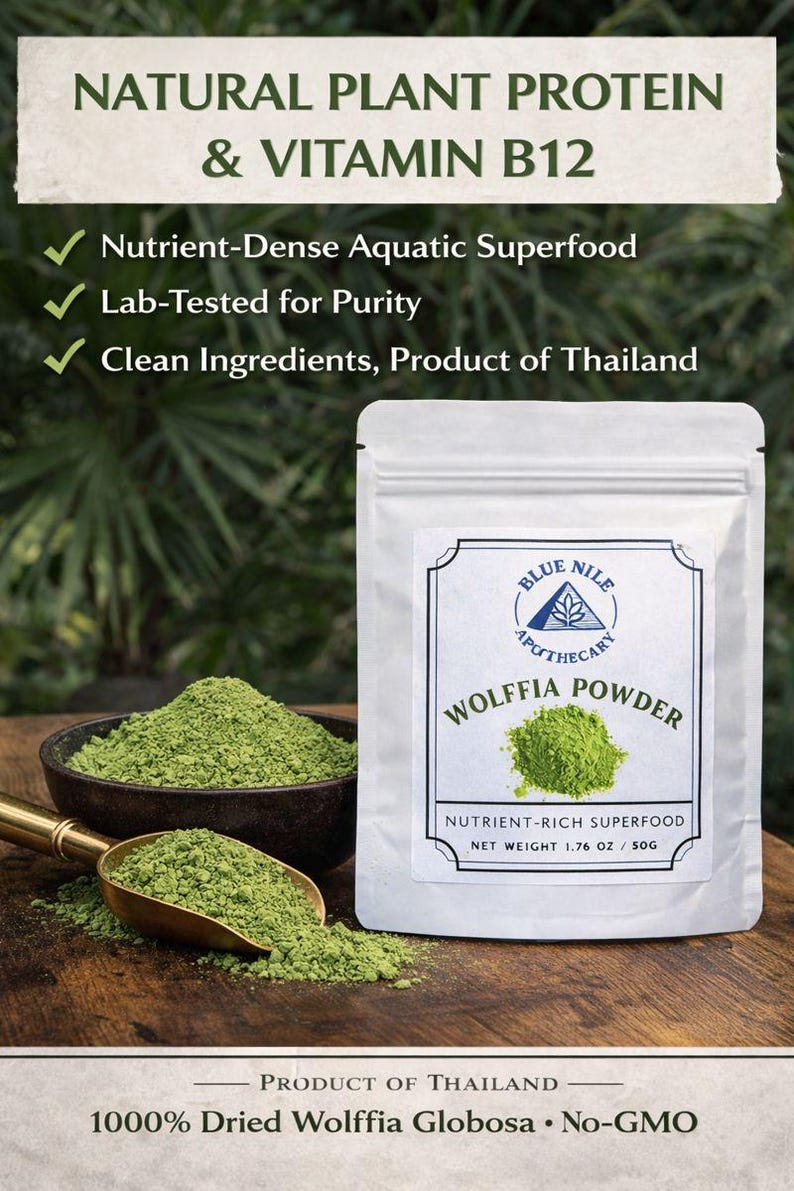 May include: A white pouch of Wolffia Powder, a nutrient-rich superfood, sits on a wooden surface. A bowl and scoop filled with green powder are next to the pouch. Text on the pouch reads "Natural Plant Protein & Vitamin B12".