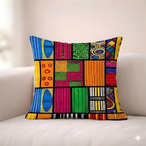 May include: Square throw pillow with a vibrant patchwork design. The pillow features a variety of colorful geometric patterns, including stripes, circles, and abstract shapes in shades of blue, yellow, pink, green, and orange, all outlined in black.
