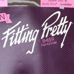 May include: A purple and pink package of Queen Fitting Pretty Sheer Pantyhose by Hanes. The package has a dotted pattern and the text "If You're Hard To Fit This Is It" and "Queen Size: B1 Barely There Sandalfoot".