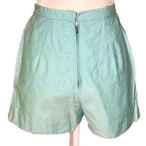 May include: A pair of light blue high-waisted shorts with a zipper closure.