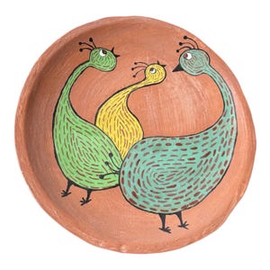 Może przedstawiać: Ceramiczna miska w kolorze terakoty z ręcznie malowanym wzorem trzech stylizowanych ptaków. Ptaki są w odcieniach zieleni i żółci, z czarnymi detalami. Miska ma prosty, zaokrąglony kształt.