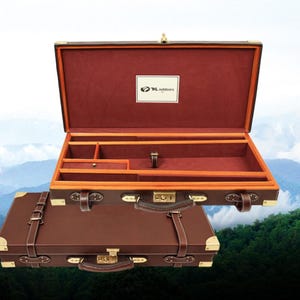May include: Brown leather briefcase with brass hardware, open to reveal a burgundy interior with compartments. The case has a handle and straps. The logo "KL outdoors" is visible inside the case.