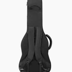 May include: A black guitar gig bag featuring a padded back panel with mesh fabric, adjustable shoulder straps, a top carry handle, and a side handle. The case has a contoured shape designed to protect a guitar during transport and storage.