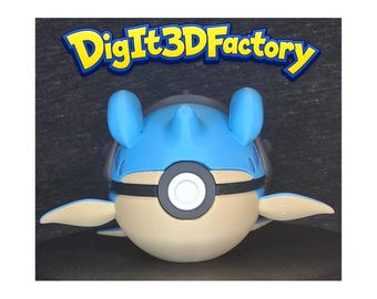 May include: A 3D printed figurine of a blue and beige spherical creature with two small fins and a black band across its center featuring a white circular button. The text DigIt3DFactory is displayed in yellow and blue letters above the figurine.