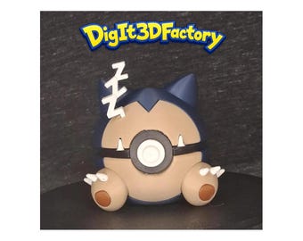 May include: A 3D printed figurine of a round, dark blue and beige creature with pointed ears, white claws, and a black band across its center. A white 'Z' symbol is attached to the top, and the text 'DigIt3DFactory' appears above the figure.