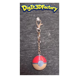 May include: A red, tan, and blue keychain featuring a ball design. The keychain has a gold-colored chain and clasp. The text "DigIt3DFactory" is visible at the top of the image.