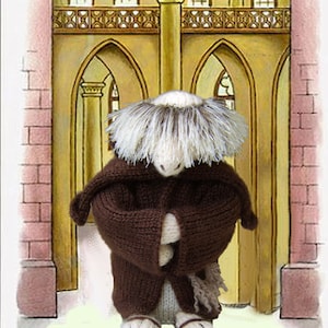 May include: A brown knitted figure wearing a hooded robe and sandals, standing in front of a yellow and brown archway with a white trim. The figure has a white and gray fuzzy head.