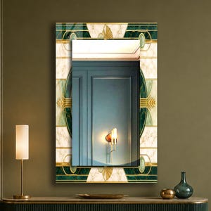 May include: A rectangular wall mirror featuring a decorative border with a white marble pattern, deep green geometric accents, and gold-toned linear details. The central glass reflects a blue panelled wall and a single wall-mounted light fixture.